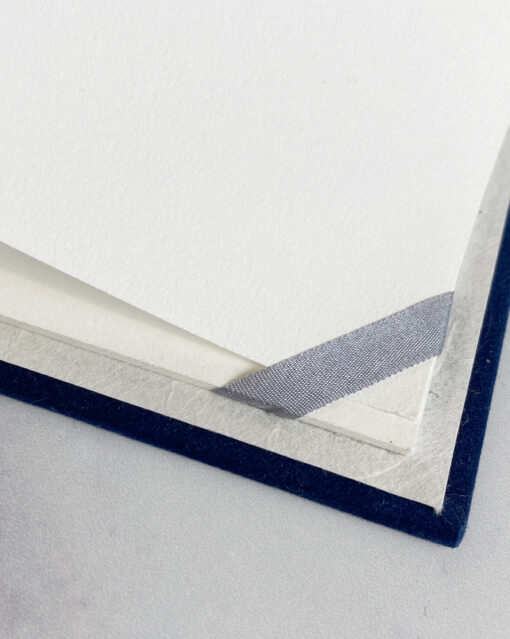 gray ribbon corners in a vow book
